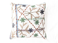 Suzani pillowcase 50x50 cm in white with colorful embroidered flowers in green, blue and gray as well as orange outlines and fringes for boho vintage