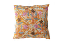 Colorful suzani pillowcase 50x50 cm with orange yellow base and embroidered flowers and sling in blue purple brown in boho vintage oriental style.